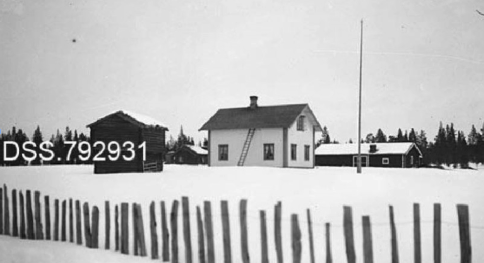 Undated black-and-white photograph of Forest Ranger Farm showing the main house, storehouse, and a wooden fence in the foreground.