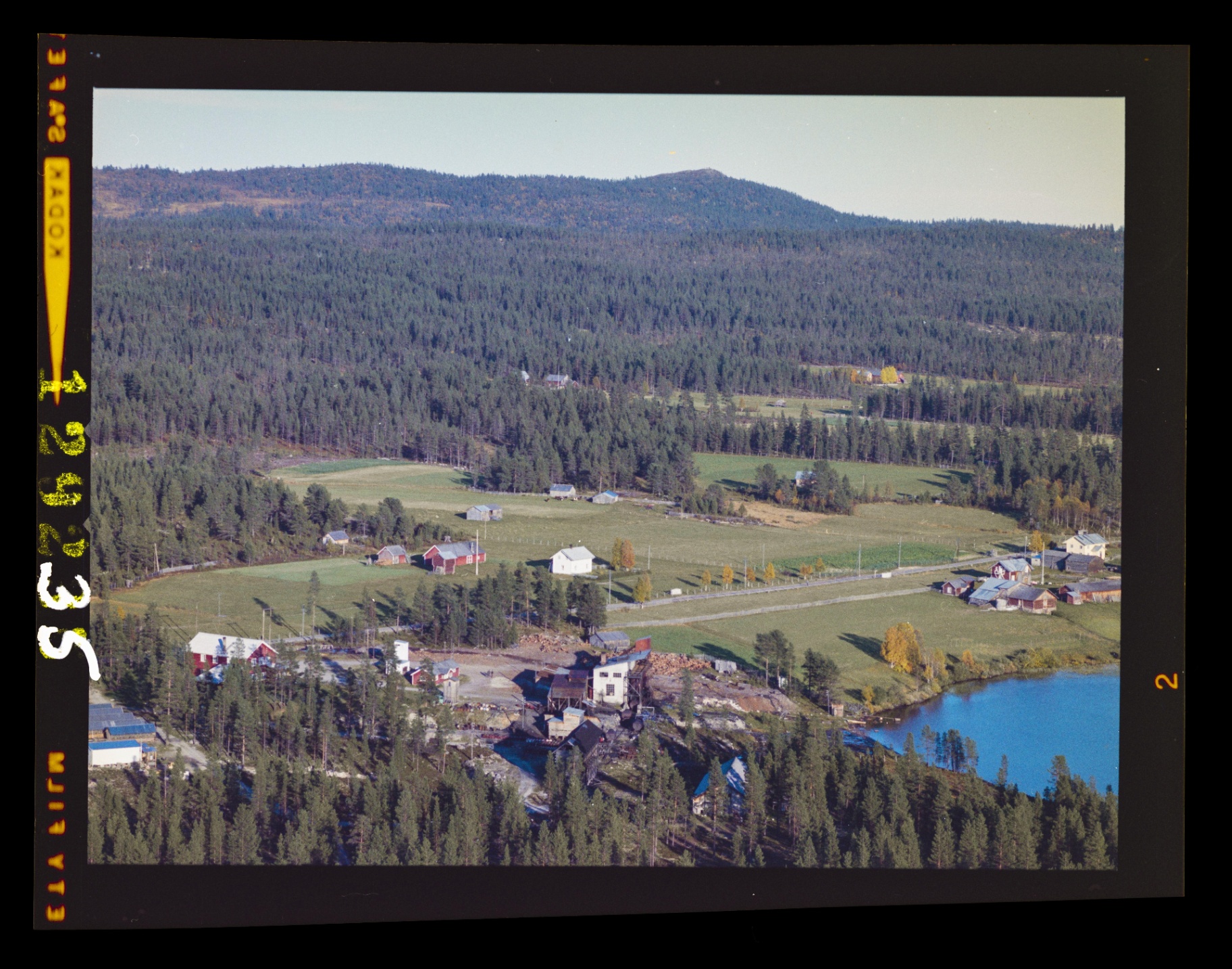 Aerial view from 1963 showing the tar kiln across from the farm, beside a small lake — the site is a campground today.